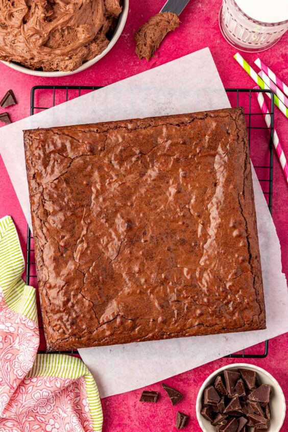 A square pan of brownies on a wire rack cooling.