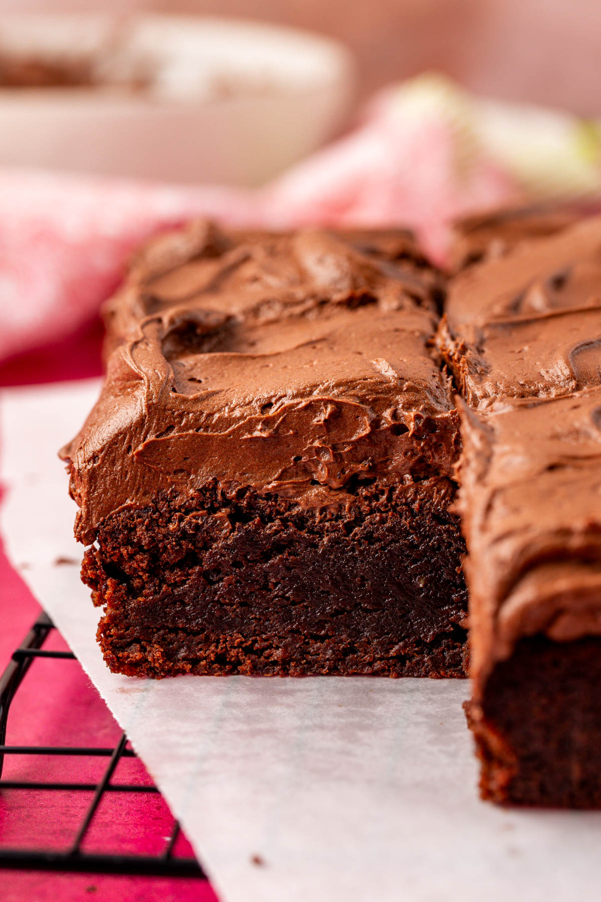 Close up of frosted brownies on a wire rack.