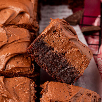 Close up of chocolate frosted brownies on a table.