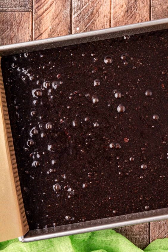 Brownie batter in a square pan ready to bake.