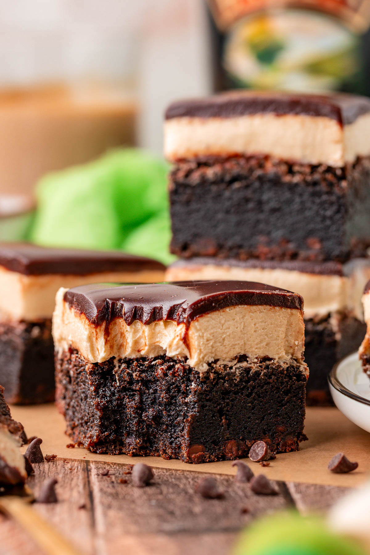 Close up of a Bailey's Brownie on a piece of parchment paper with a bite taken out of it.