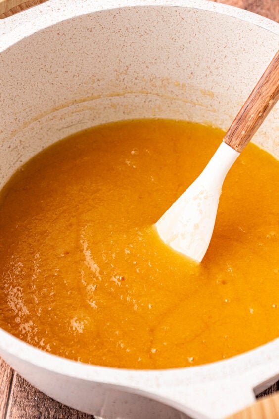 Melted butter and sugar mixture being stirred in a pot.