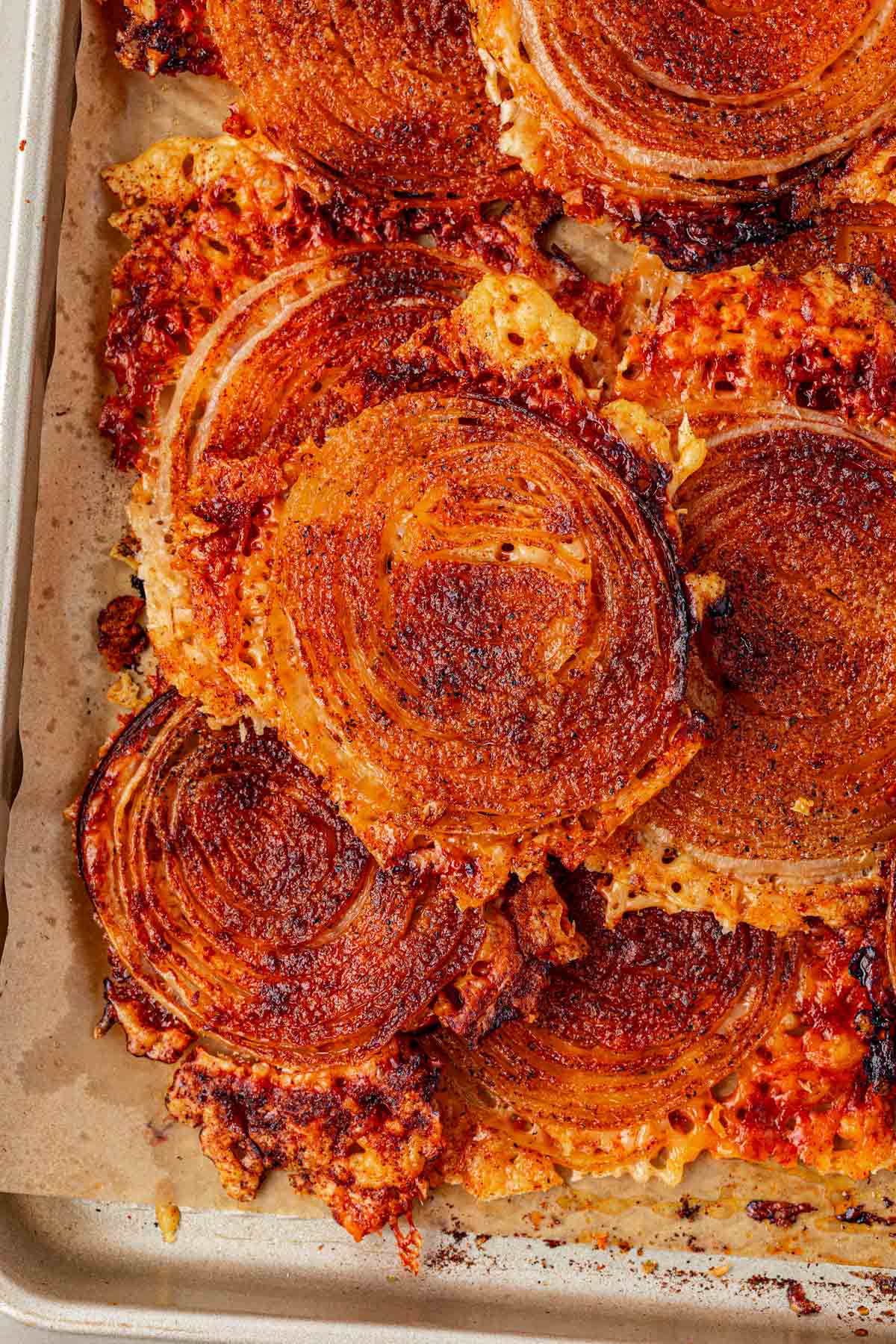 Onion rings chips on a parchment lined pan.